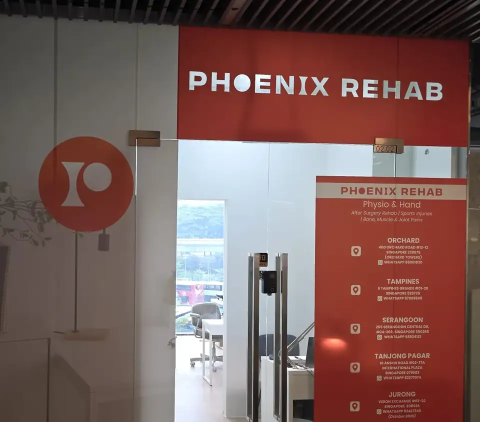 Entrance of Phoenix Rehab Physio and Hand Jurong East at Vision Exchange, unit #02-02, with the clinic sign and glass door