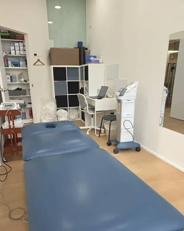 Treatment room at Phoenix Rehab Jurong East, with a treatment bed, therapist desk and electrotherapy unit